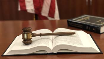 Gavel sitting on a legal textbook 